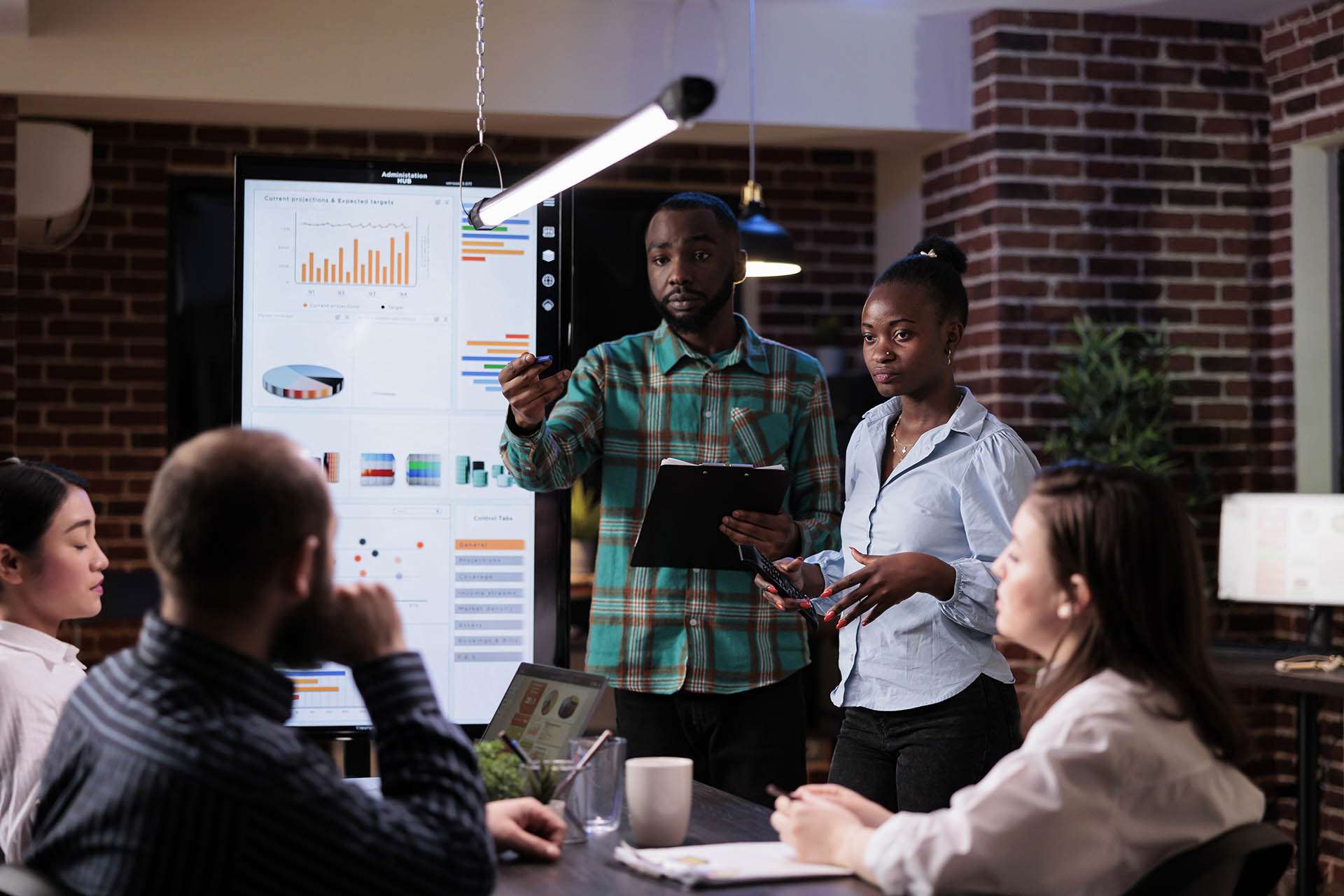 African american work colleagues brainstorming marketing strategy with sales team working overtime